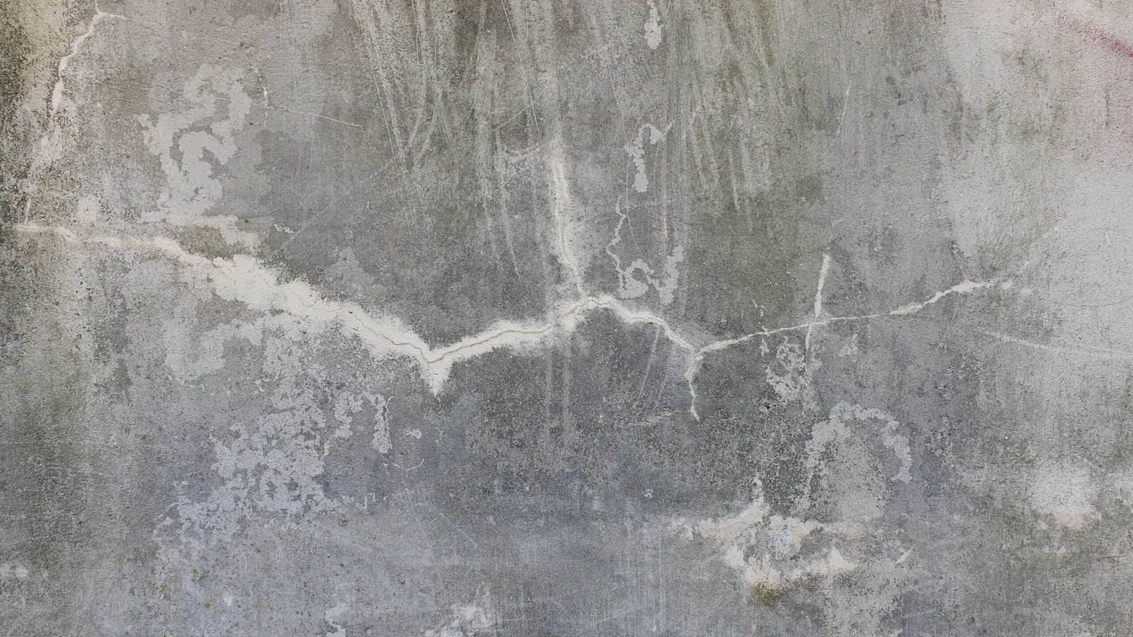 Weathered, cracked concrete surface before repair