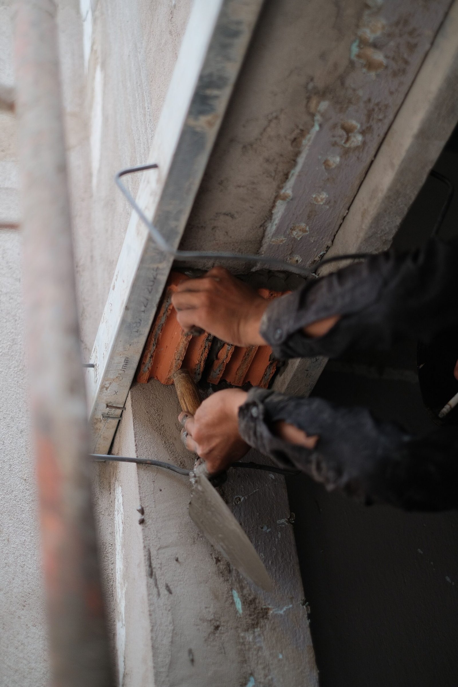Technician repairing damaged concrete with a trowel