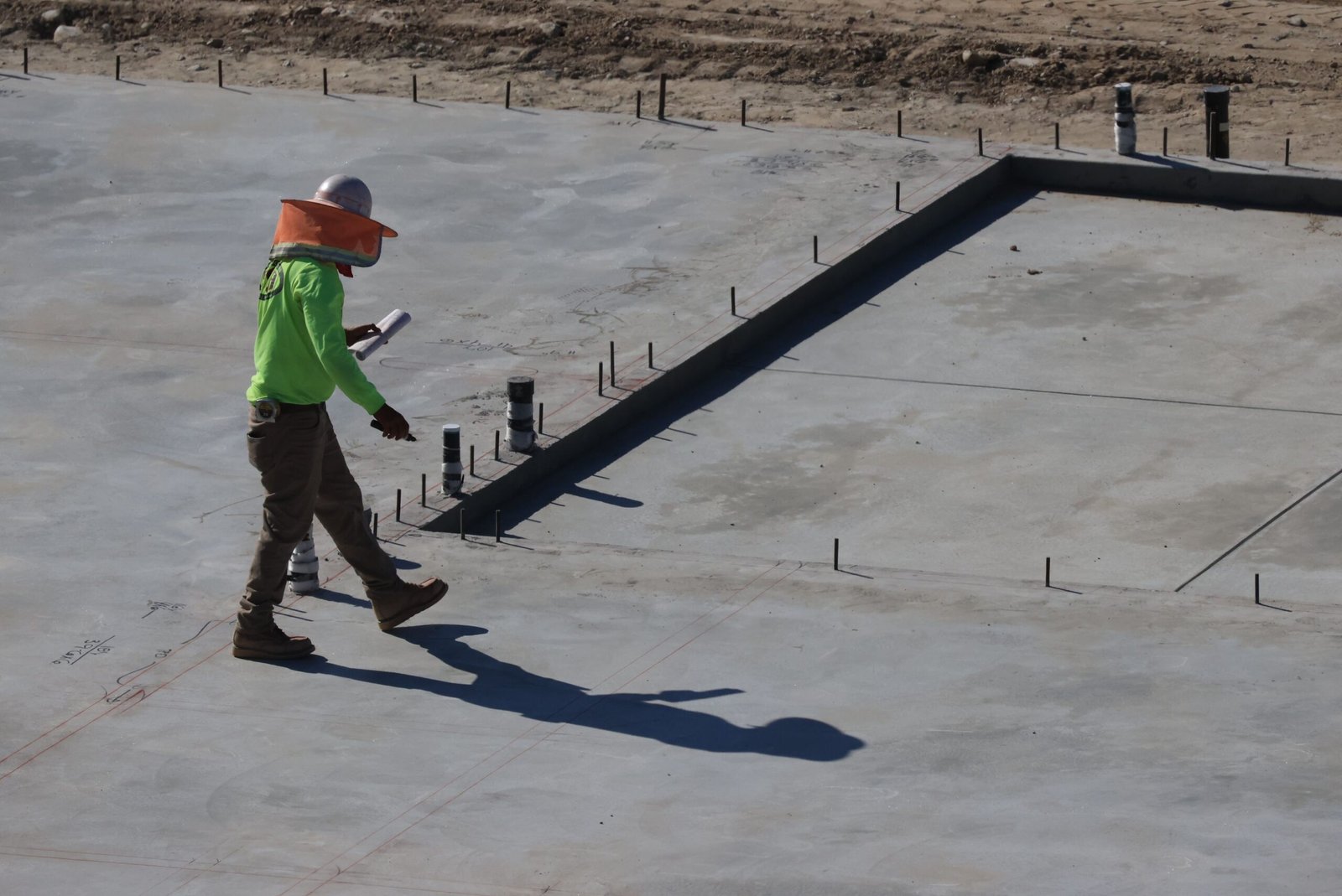 Structural engineer inspecting a concrete slab on a construction site